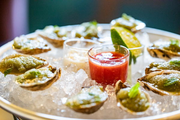 Incanto signature oysters served on ice with cucumber mint granita, habanero tincture, cocktail sauce, and horseradish.