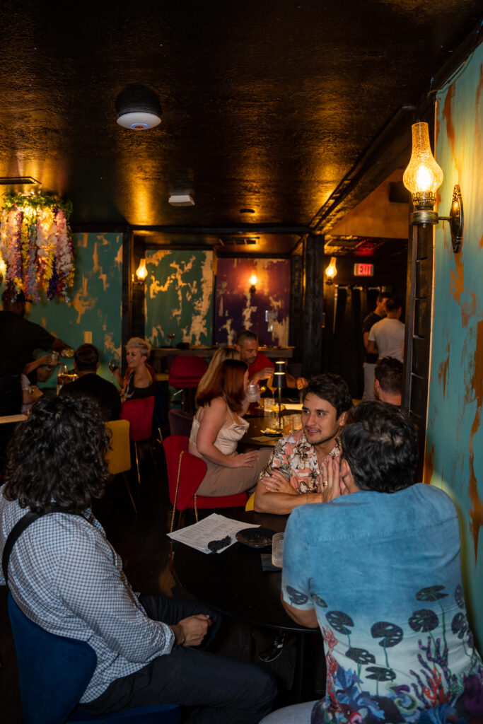 Incanto happy hour cocktails guests enjoying drinks inside cocktail bar in Houston Heights